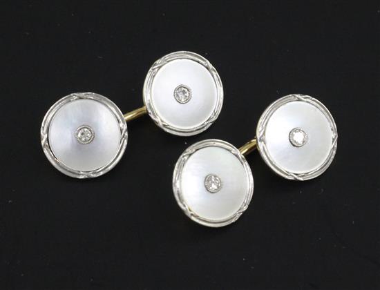 A pair of mid 20th century 14ct gold, mother of pearl and diamond set circular cufflinks.